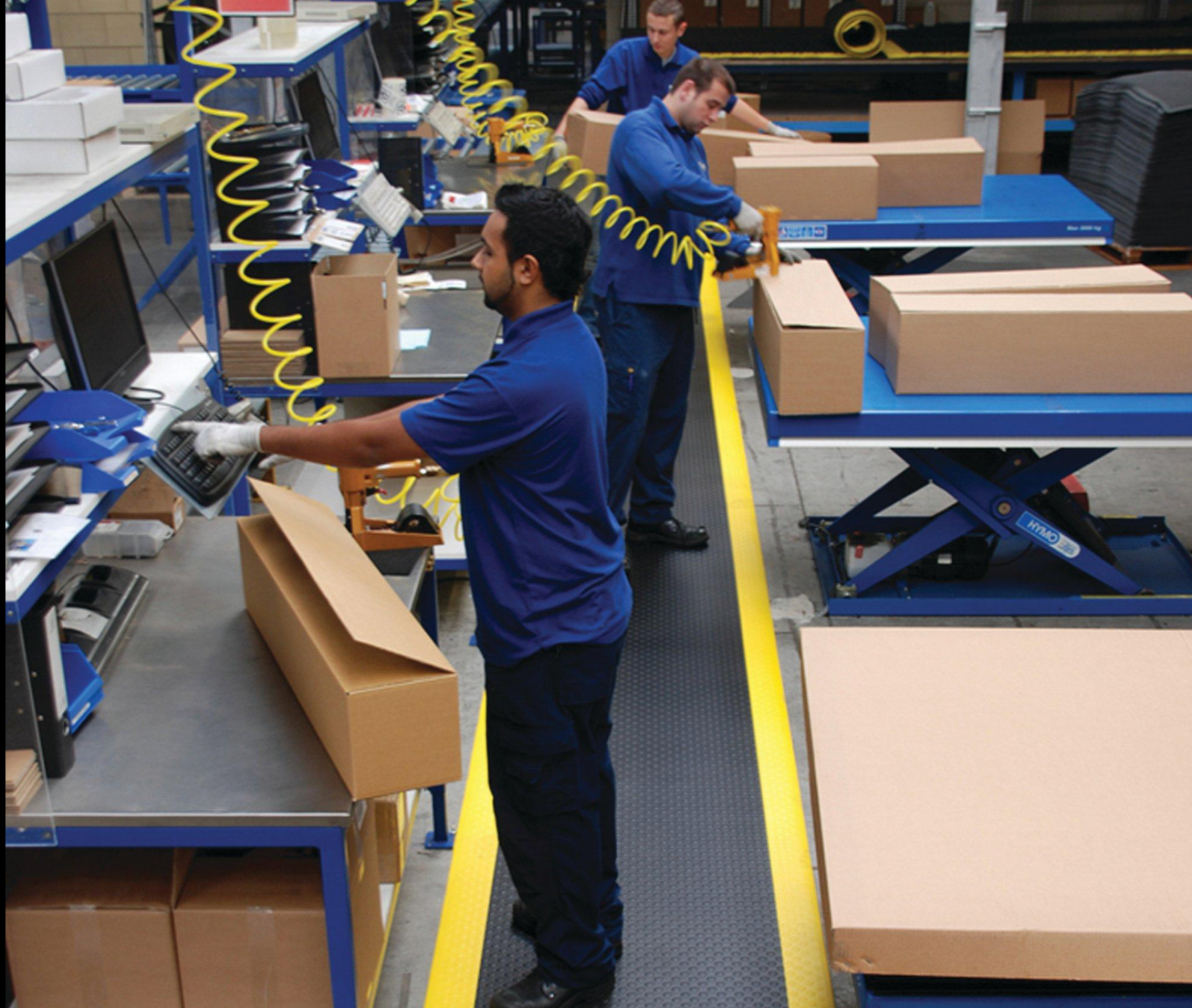 Factory team coordinating product manufacturing and packing