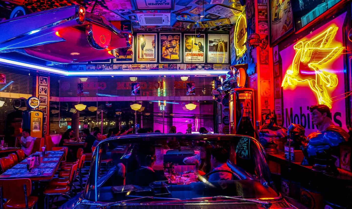 Neon-lit bar interior with red blue and yellow ambient lighting